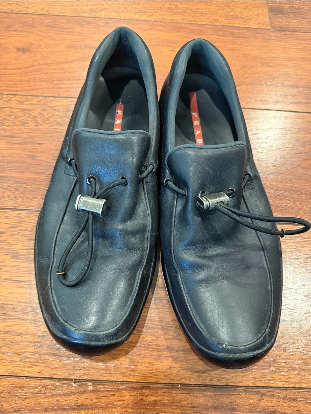 Prada Black Leather Slip-On Loafers with Toggle Accent